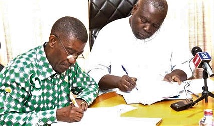 J. B. Koranteng-Yorke (right), Vice-President of the 1982 year group, and Henry Arthur-Gyan, the Headteacher of the school, signing copies of the contract J. B. Koranteng-Yorke (right), Vice-President of the 1982 year group, and Henry Arthur-Gyan, the Headteacher of the school, signing copies of the contract